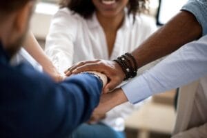 Diverse hands together in support — alcohol and drug recovery aftercare Johannesburg